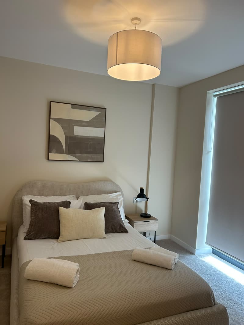 Double bedroom made up with cushions and towels